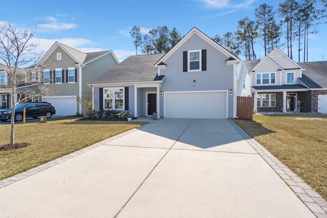 traditional home featuring driveway, a front lawn, and an attached garage