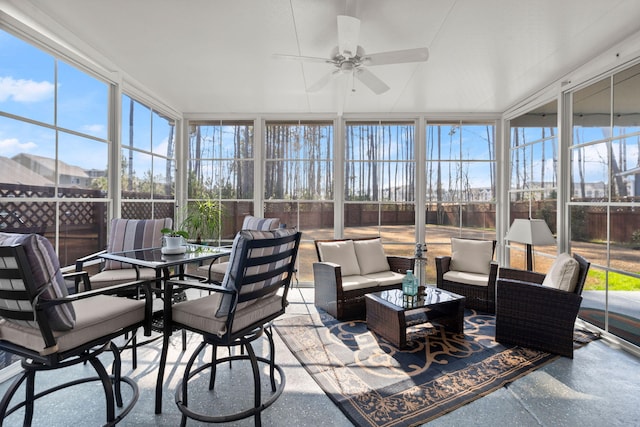 sunroom / solarium with a ceiling fan