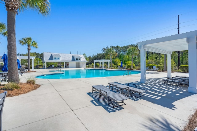 community pool with a patio area and a pergola