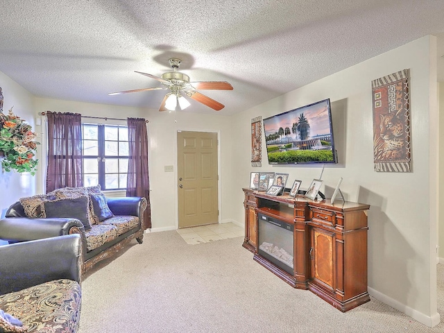 carpeted living room featuring ceiling fan and a textured ceiling