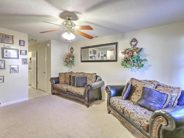 carpeted living room featuring a textured ceiling and ceiling fan