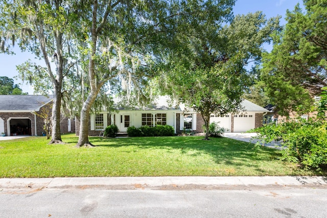 single story home with an attached garage, a front lawn, concrete driveway, and brick siding