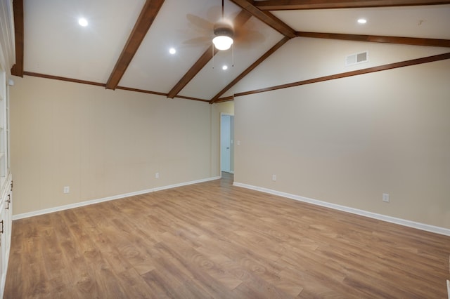 unfurnished room with ceiling fan, vaulted ceiling with beams, visible vents, baseboards, and light wood-style floors