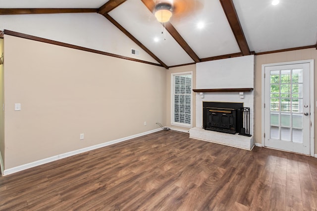 unfurnished living room with a brick fireplace, visible vents, beamed ceiling, and wood finished floors