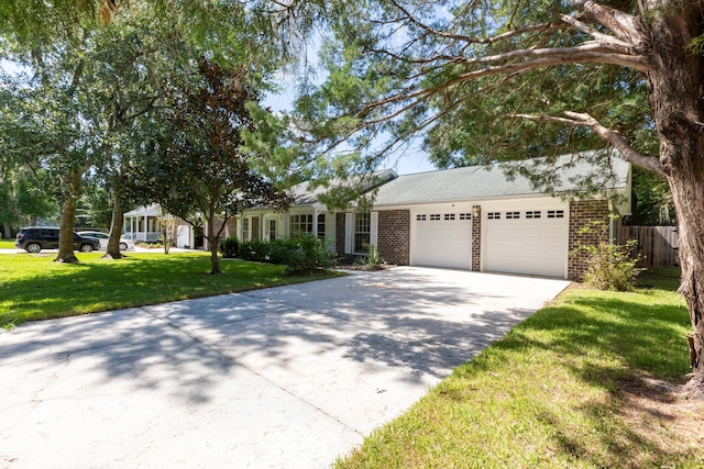 ranch-style home with a garage, a front yard, brick siding, and driveway