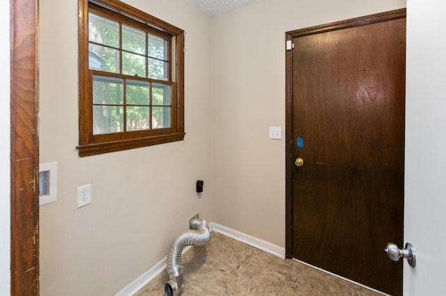 washroom featuring laundry area and baseboards