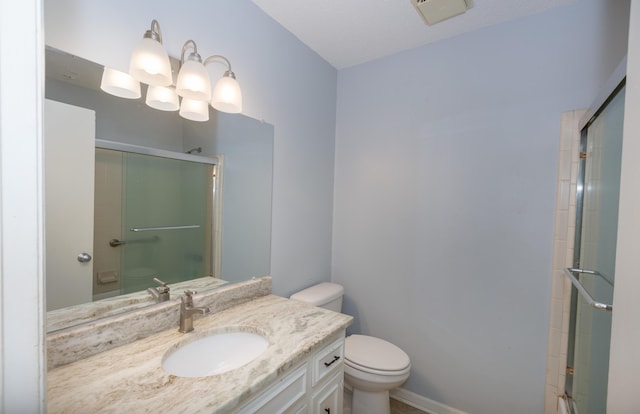 full bath featuring toilet, visible vents, vanity, and a shower with shower door