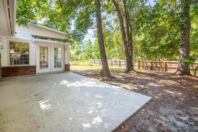 view of patio with french doors and a fenced backyard