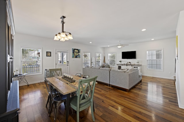 dining room featuring dark wood-style floors, recessed lighting, baseboards, and ceiling fan with notable chandelier