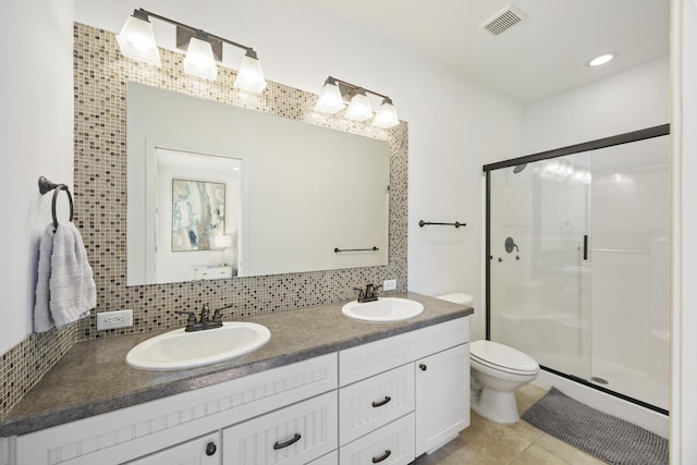 full bath with a stall shower, tasteful backsplash, visible vents, and a sink