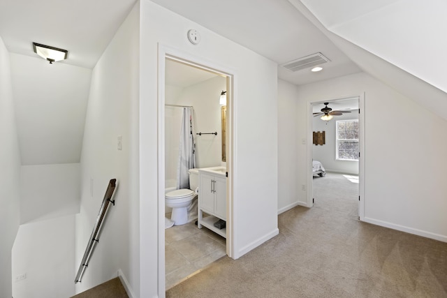 full bath featuring baseboards, visible vents, toilet, vaulted ceiling, and vanity