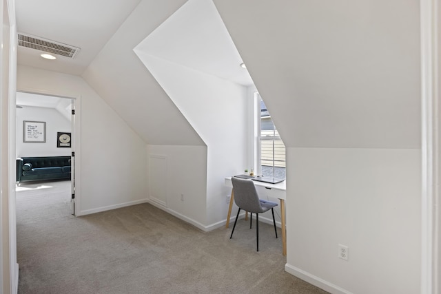 office space featuring carpet floors, visible vents, vaulted ceiling, and baseboards