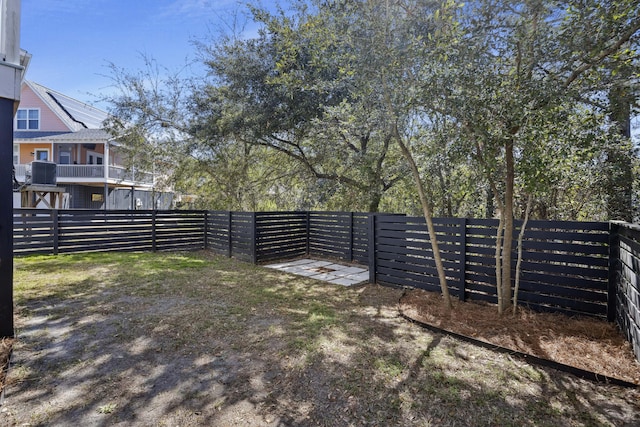 view of yard featuring central AC unit and a fenced backyard