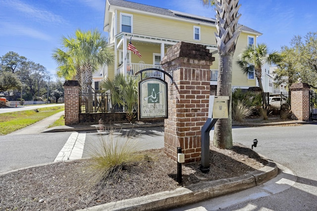 view of front of house with a gate, fence, and brick siding