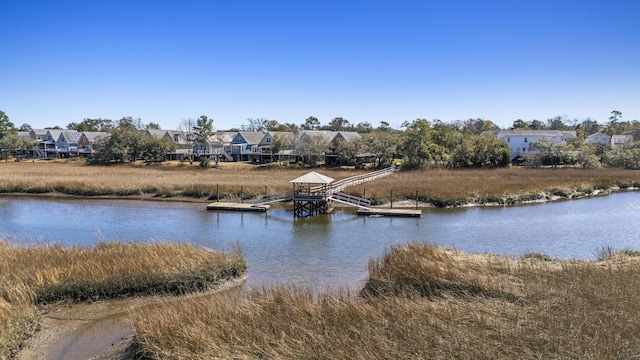 view of water feature with a residential view and a boat dock