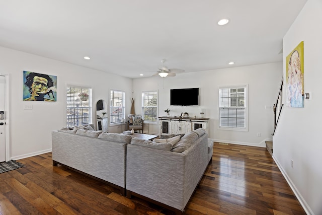 living room featuring dark wood-style floors, recessed lighting, and baseboards