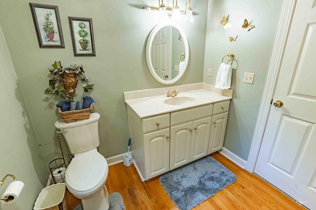 bathroom featuring vanity, hardwood / wood-style flooring, and toilet