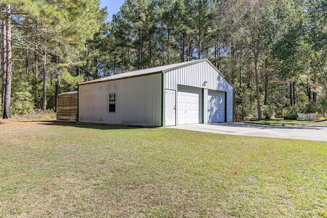 garage featuring a lawn