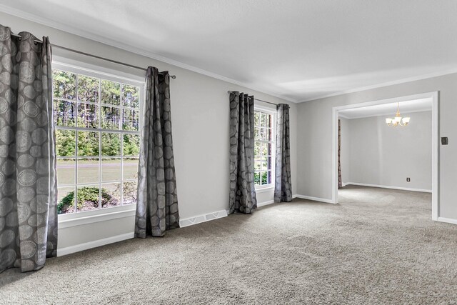 carpeted spare room featuring a notable chandelier, visible vents, baseboards, and ornamental molding