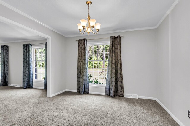 carpeted spare room with a notable chandelier, baseboards, visible vents, and ornamental molding