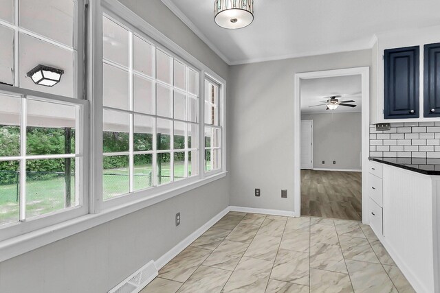 unfurnished dining area featuring a wealth of natural light, visible vents, marble finish floor, and a ceiling fan