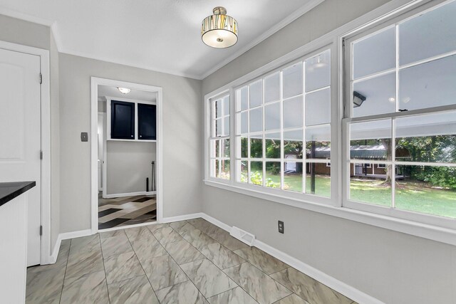 unfurnished dining area with visible vents, baseboards, marble finish floor, and ornamental molding