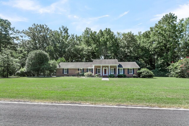 ranch-style home with a front yard and brick siding