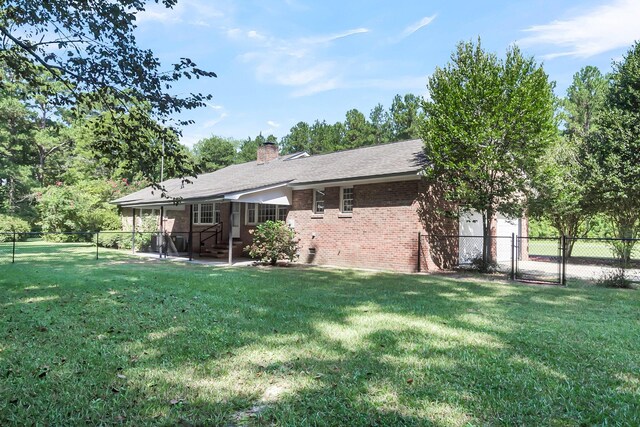 view of yard featuring a patio area, a gate, and a fenced backyard