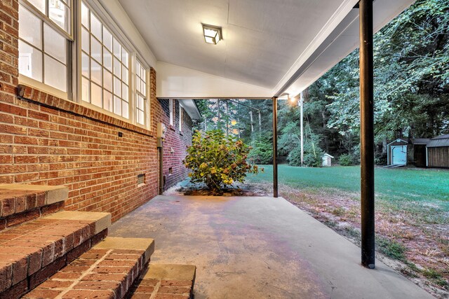 view of patio featuring an outbuilding and a shed