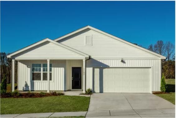 view of front of house with a garage and a front lawn