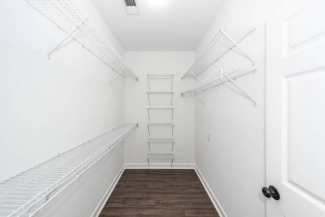 walk in closet with dark wood-style floors and visible vents