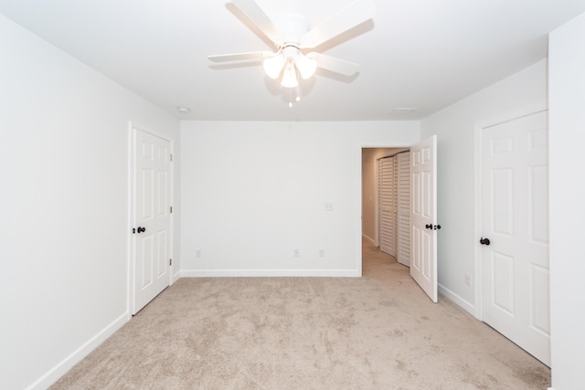 unfurnished room featuring light carpet, ceiling fan, and baseboards