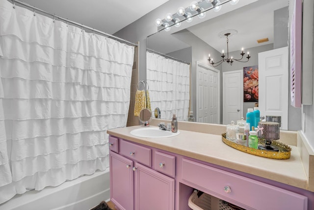 bathroom with vanity, a chandelier, and shower / bath combo with shower curtain