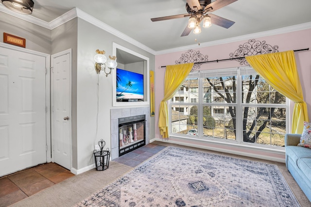 living room featuring crown molding, tile patterned floors, a tile fireplace, and ceiling fan