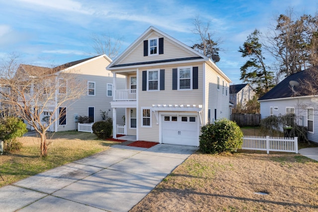 view of front of home featuring driveway, a balcony, an attached garage, fence, and a front yard