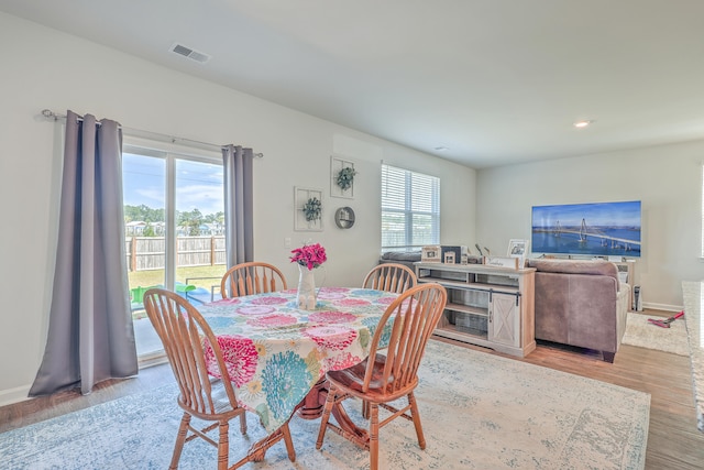 dining area with light hardwood / wood-style flooring and plenty of natural light