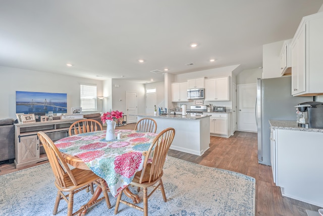 dining space with wood-type flooring and sink