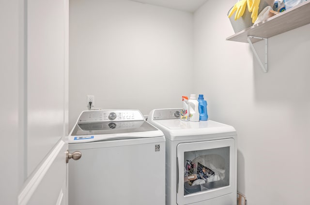 laundry room featuring washing machine and clothes dryer