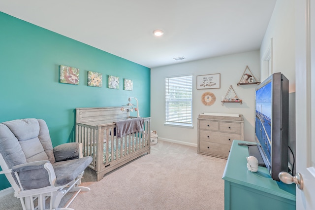 carpeted bedroom with a crib