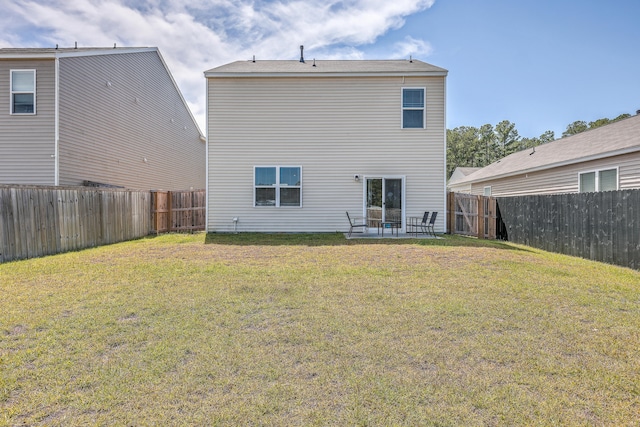 back of house featuring a lawn