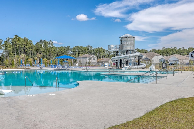 view of swimming pool featuring a patio and a water slide