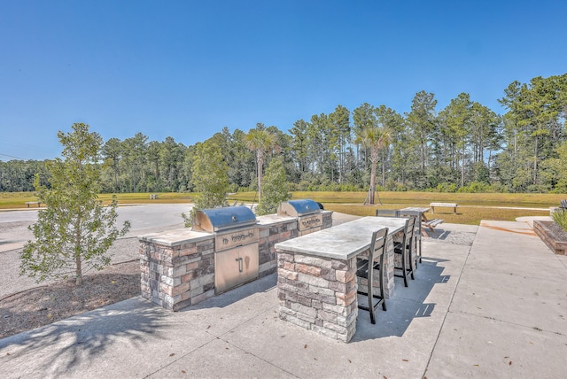 view of patio with exterior kitchen and grilling area