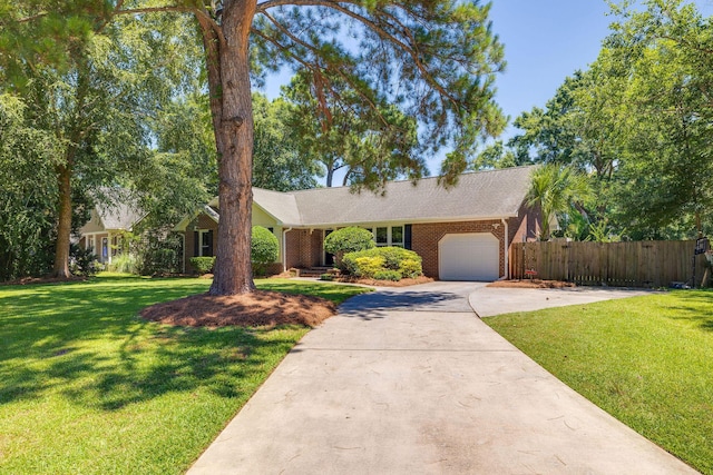 ranch-style house featuring an attached garage, a front lawn, concrete driveway, and brick siding