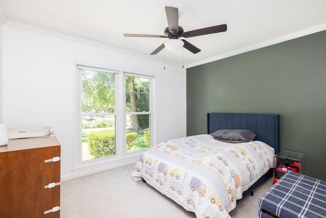 carpeted bedroom featuring ceiling fan and ornamental molding