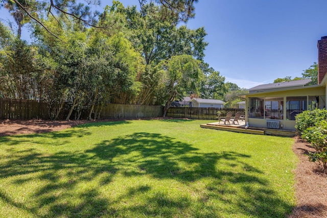 view of yard featuring a fenced backyard and a sunroom