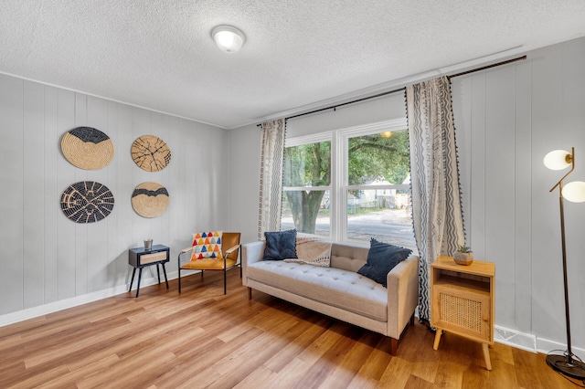 living area featuring hardwood / wood-style floors and a textured ceiling