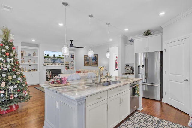 kitchen featuring an island with sink, stainless steel appliances, sink, and white cabinets