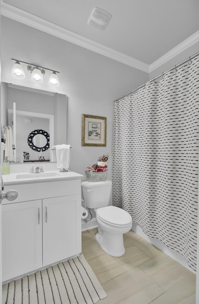 bathroom with vanity, crown molding, toilet, and walk in shower