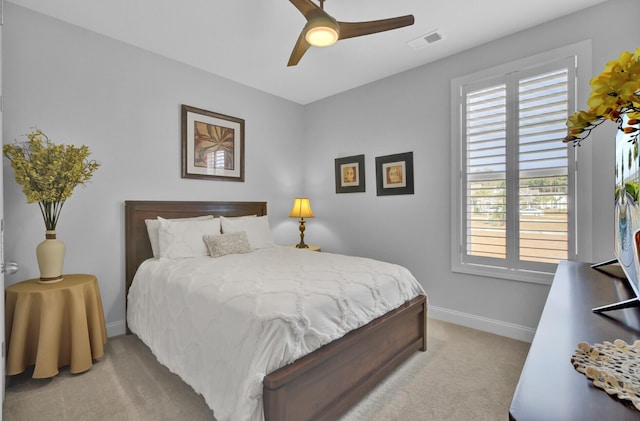 carpeted bedroom featuring multiple windows and ceiling fan