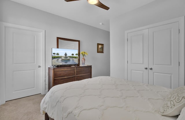 carpeted bedroom with ceiling fan and a closet